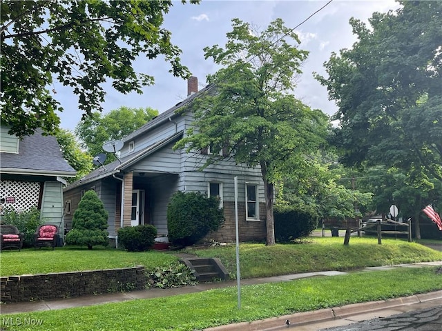 907 Lovers Ln, Akron, OH 44306 - view of front facade with a front yard and a chimney