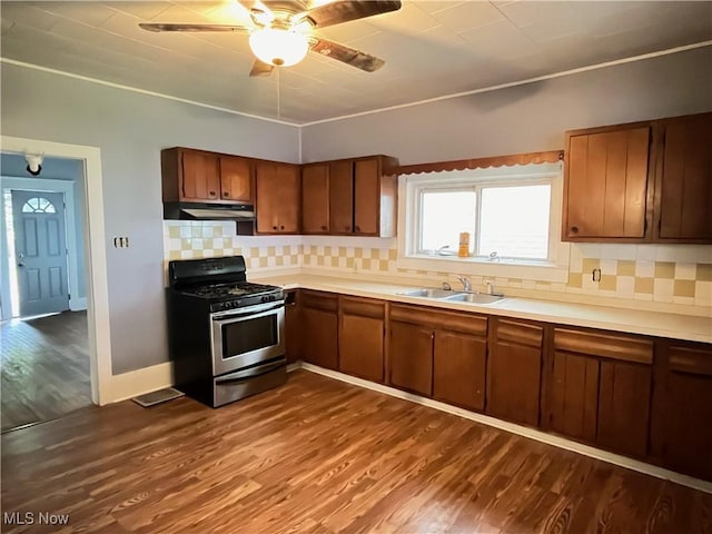 907 Lovers Ln, Akron, OH 44306 - kitchen with stainless steel range with gas cooktop, under cabinet range hood, dark wood-style floors, brown cabinetry, and light countertops
