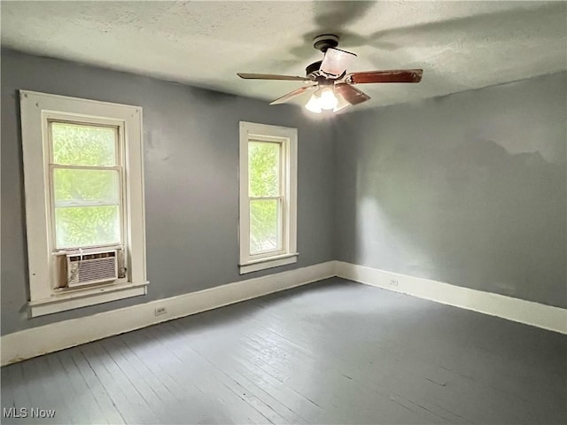 907 Lovers Ln, Akron, OH 44306 - spare room with a ceiling fan, wood-type flooring, a textured ceiling, and cooling unit