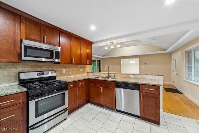 3965 Ellendale Rd, Chagrin Falls, OH 44022 - kitchen with stainless steel appliances, a peninsula, backsplash, lofted ceiling, and light stone countertops