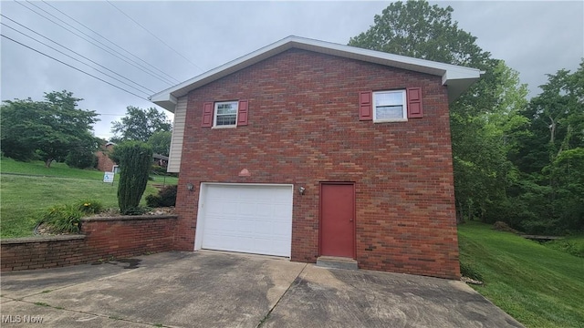 112 Laurel Ln, Washington, WV 26181 - view of property exterior with a garage, a yard, driveway, and brick siding