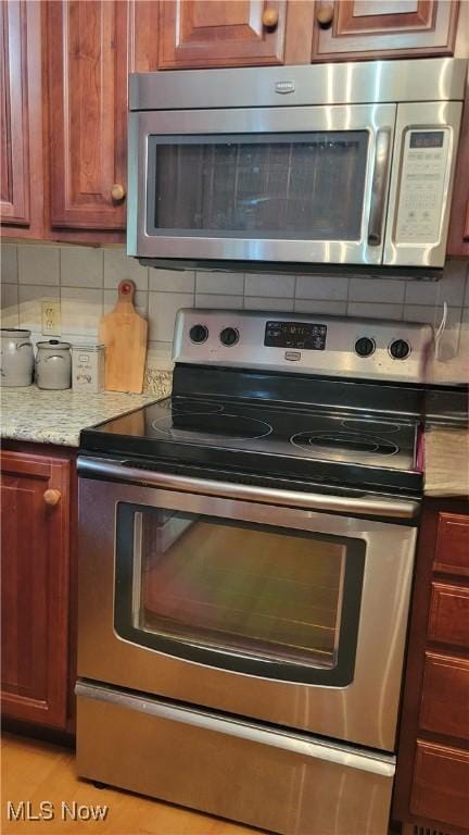 112 Laurel Ln, Washington, WV 26181 - kitchen featuring appliances with stainless steel finishes and decorative backsplash