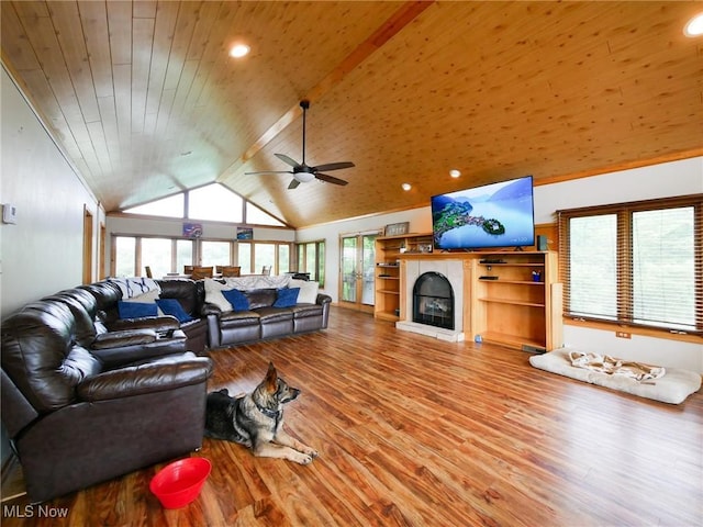 32701 Gundy Ridge Rd, Bowerston, OH 44695 - living area featuring vaulted ceiling, wood finished floors, a tile fireplace, a ceiling fan, and wood ceiling