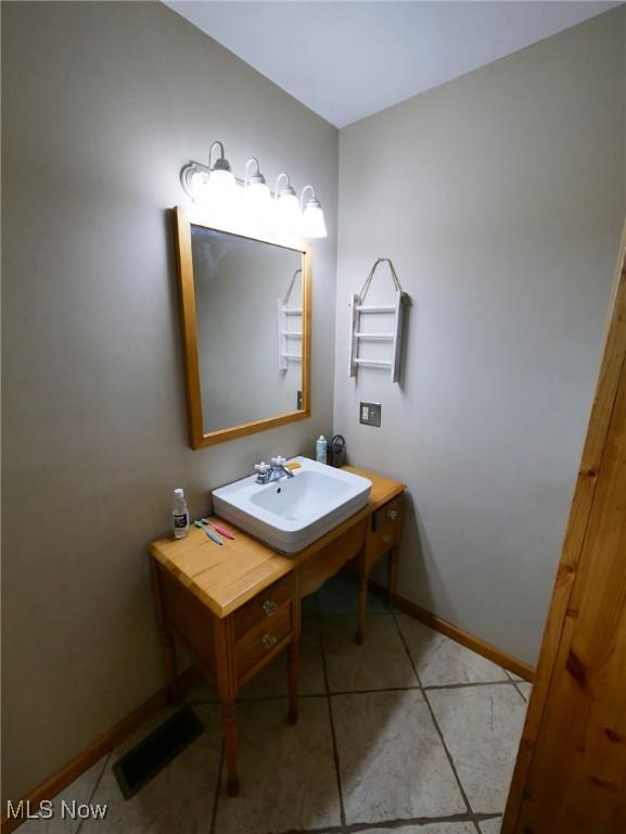 32701 Gundy Ridge Rd, Bowerston, OH 44695 - bathroom featuring a sink and tile patterned floors