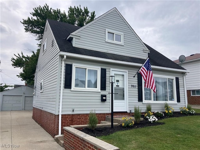 7611 Liberty Ave, Parma, OH 44129 - view of front of home with an outdoor structure, a front lawn, a detached garage, and roof with shingles