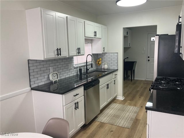 7611 Liberty Ave, Parma, OH 44129 - kitchen with dishwasher, white cabinets, light wood finished floors, and tasteful backsplash