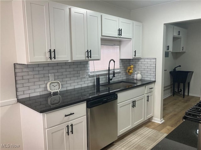 7611 Liberty Ave, Parma, OH 44129 - kitchen with stainless steel dishwasher, light wood finished floors, tasteful backsplash, and white cabinets