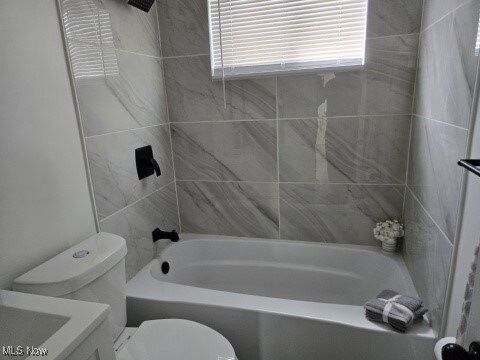 7611 Liberty Ave, Parma, OH 44129 - bathroom featuring vanity and bathing tub / shower combination
