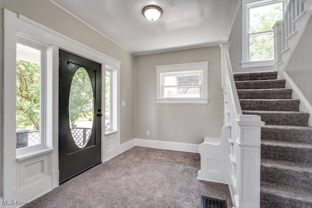 1017 Smith Ave SW, Canton, OH 44706 - entrance foyer featuring carpet floors, stairway, and healthy amount of natural light