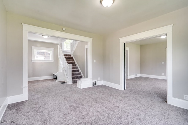 1017 Smith Ave SW, Canton, OH 44706 - carpeted spare room with stairs and baseboards