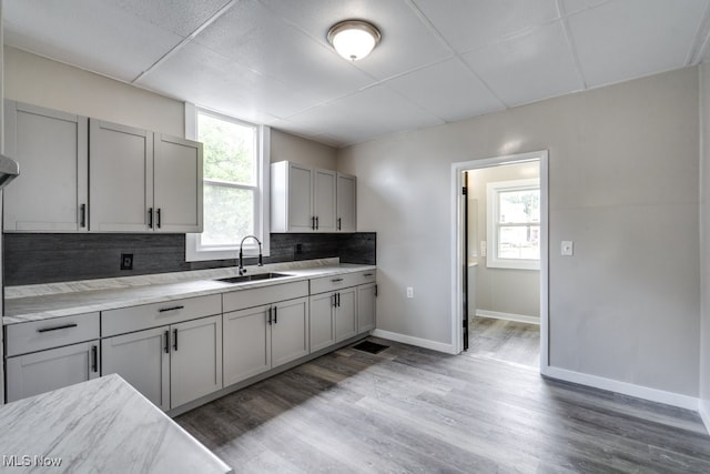1017 Smith Ave SW, Canton, OH 44706 - kitchen featuring backsplash, healthy amount of natural light, gray cabinetry, light countertops, and a drop ceiling