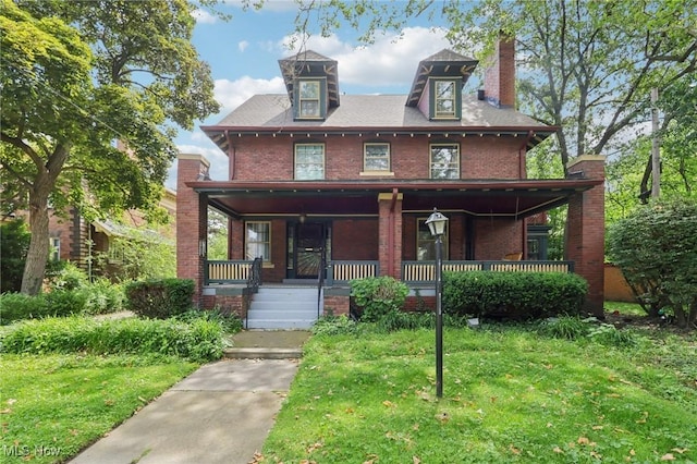 1575 E 108th St, Cleveland, OH 44106 - american foursquare style home featuring brick siding, a front lawn, covered porch, and a chimney