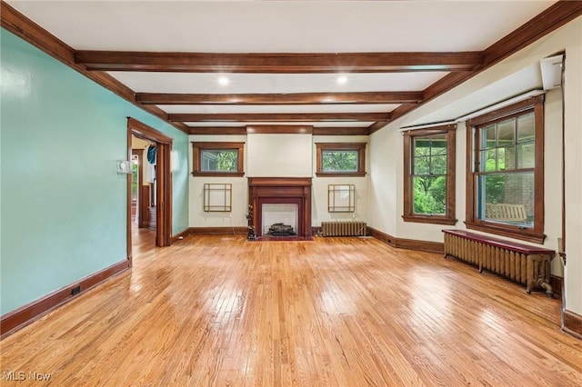 1575 E 108th St, Cleveland, OH 44106 - unfurnished living room with radiator heating unit, beamed ceiling, light wood-style flooring, and a fireplace with flush hearth