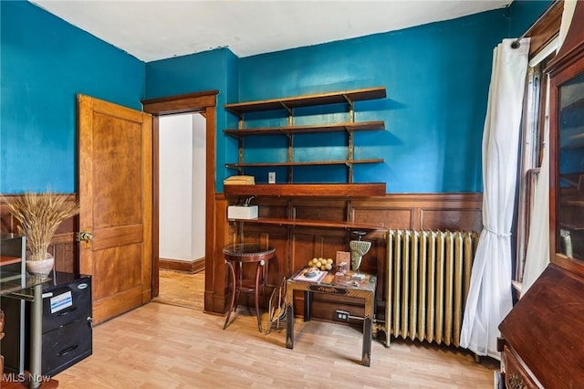 1575 E 108th St, Cleveland, OH 44106 - living area featuring radiator, wood finished floors, and wainscoting