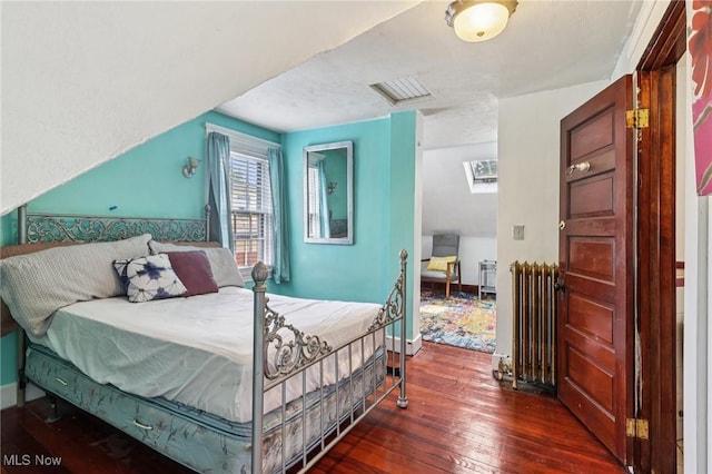 1575 E 108th St, Cleveland, OH 44106 - bedroom featuring radiator heating unit and dark wood finished floors