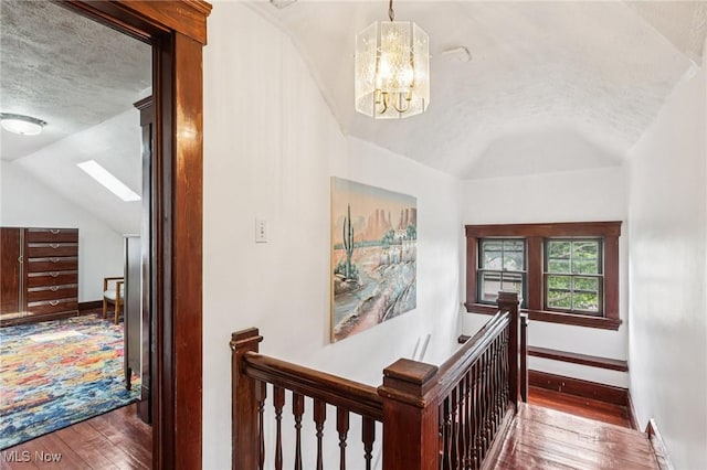 1575 E 108th St, Cleveland, OH 44106 - stairway with lofted ceiling, a textured ceiling, wood-type flooring, and a chandelier