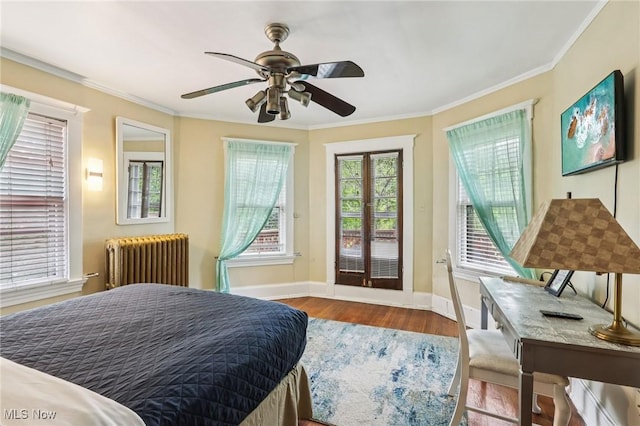 1575 E 108th St, Cleveland, OH 44106 - bedroom featuring radiator heating unit, wood finished floors, crown molding, access to outside, and a ceiling fan