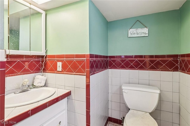 1575 E 108th St, Cleveland, OH 44106 - half bath with vanity, tile walls, and wainscoting