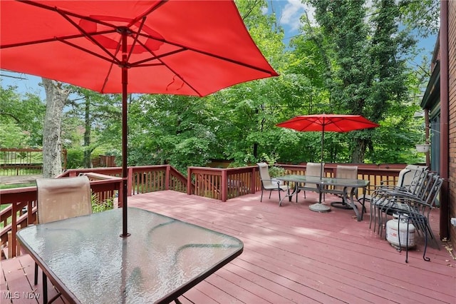 1575 E 108th St, Cleveland, OH 44106 - wooden deck with outdoor dining area and view of wooded area