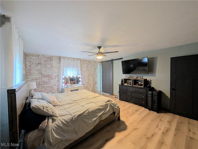 3439 Rough And Ready Rd, New Concord, OH 43762 - bedroom featuring brick wall, light wood-style flooring, and ceiling fan