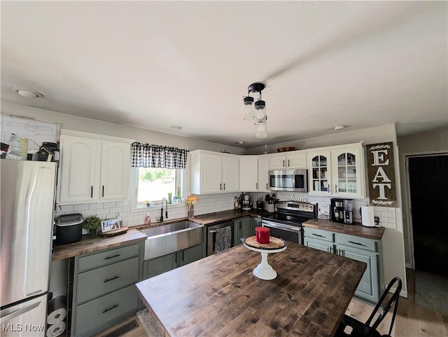 3439 Rough And Ready Rd, New Concord, OH 43762 - kitchen featuring appliances with stainless steel finishes, wooden counters, backsplash, and white cabinetry