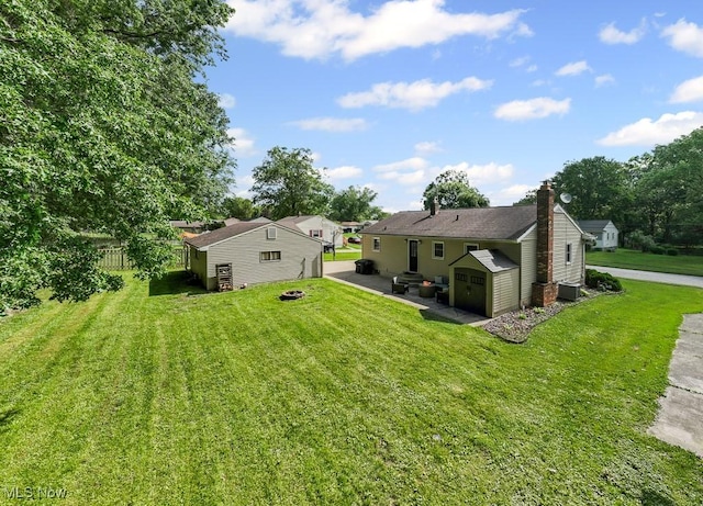 4000 Kenneth Rd, Stow, OH 44224 - rear view of house with a shed, a patio, a chimney, and an outdoor fire pit