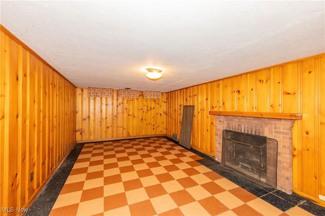 3526 Raymont Blvd, University Heights, OH 44118 - unfurnished living room featuring tile patterned floors, a brick fireplace, and wood walls