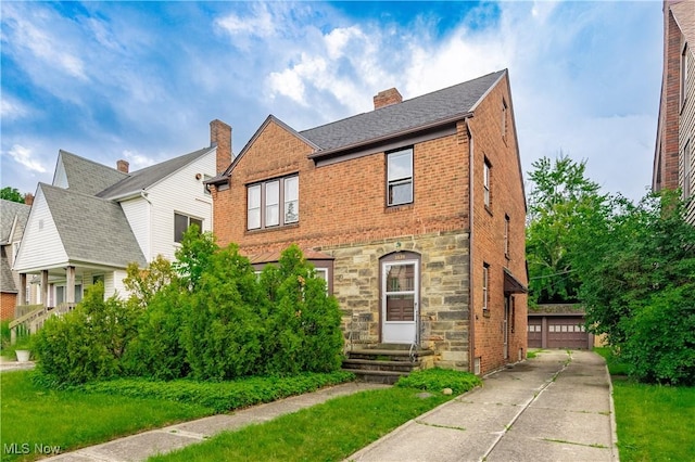 3526 Raymont Blvd, University Heights, OH 44118 - view of front of house with brick siding, stone siding, a chimney, and an outdoor structure