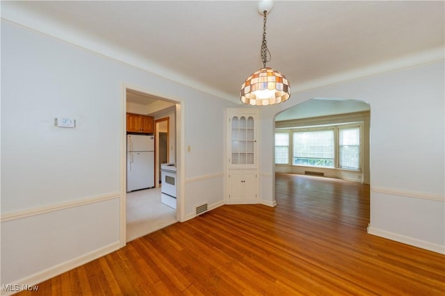 3526 Raymont Blvd, University Heights, OH 44118 - spare room with wood finished floors and arched walkways