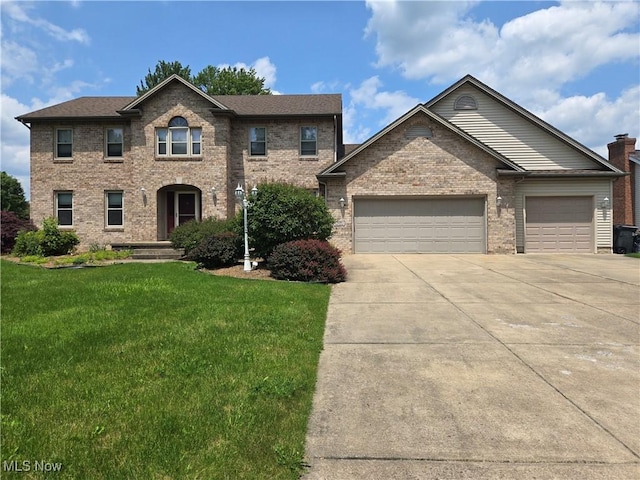 5256 S Saratoga Ave, Austintown, OH 44515 - traditional-style house featuring concrete driveway, a front yard, a garage, and brick siding