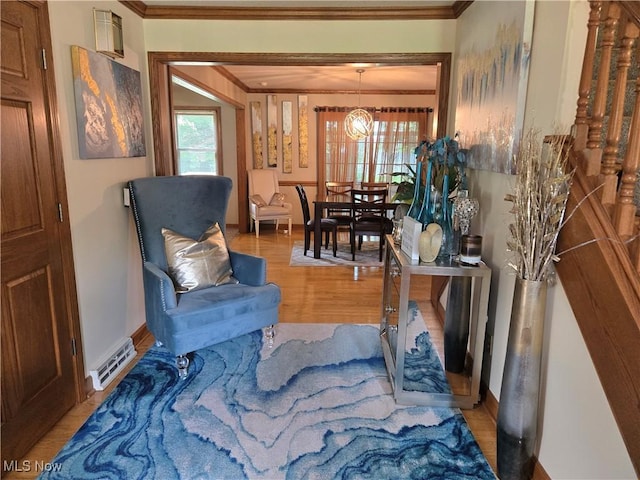 5256 S Saratoga Ave, Austintown, OH 44515 - living area with crown molding, a chandelier, and light wood finished floors