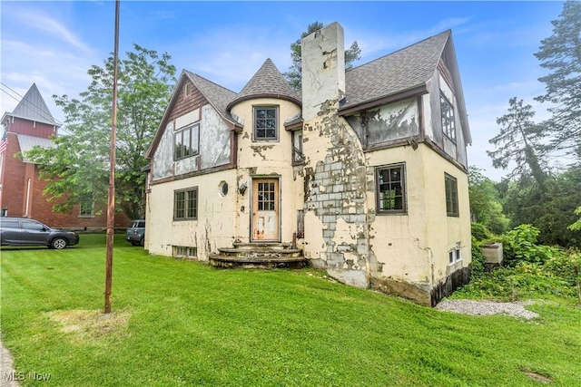 202 N State St, Rochester, OH 44090 - view of front of house with stucco siding, a front lawn, and a shingled roof