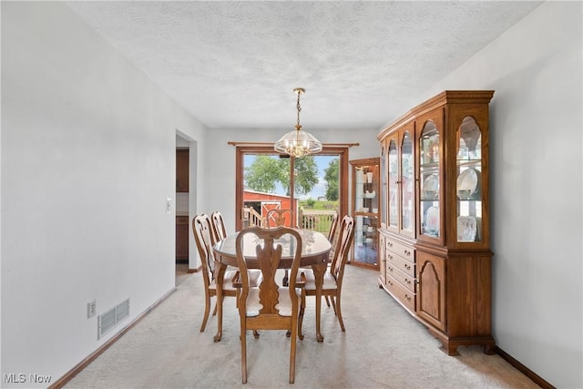 8471 Henry St, Navarre, OH 44662 - dining room featuring a chandelier, light colored carpet, and a textured ceiling