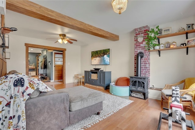 4495 Old River Rd, Philo, OH 43771 - living room with a wood stove, wood finished floors, a ceiling fan, and beamed ceiling