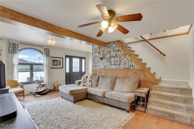4495 Old River Rd, Philo, OH 43771 - living area featuring stairs, beamed ceiling, wood finished floors, and a ceiling fan