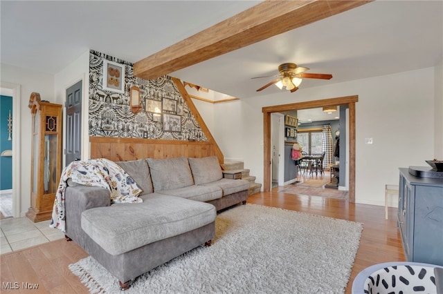 4495 Old River Rd, Philo, OH 43771 - living room featuring light wood-type flooring, a ceiling fan, beamed ceiling, and stairway