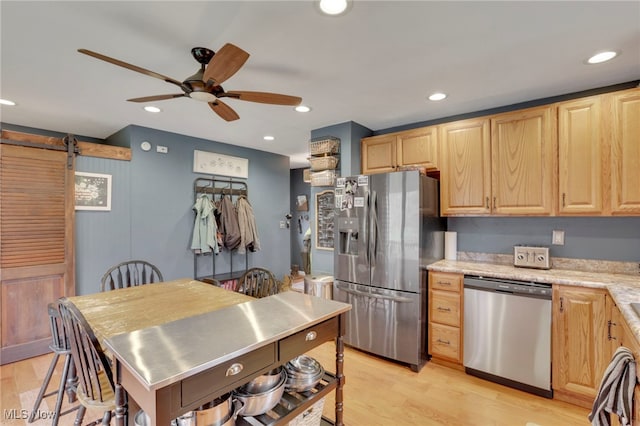 4495 Old River Rd, Philo, OH 43771 - kitchen with appliances with stainless steel finishes, stainless steel counters, light brown cabinets, a barn door, and recessed lighting