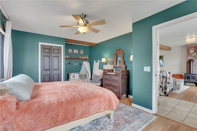 4495 Old River Rd, Philo, OH 43771 - bedroom with wood finished floors, a wood stove, and a ceiling fan