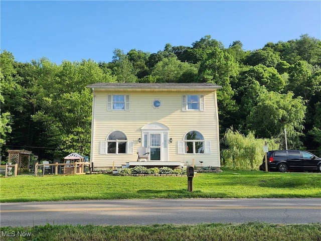 4495 Old River Rd, Philo, OH 43771 - colonial inspired home featuring a front yard and a view of trees
