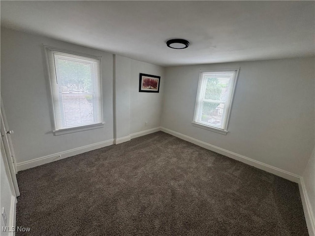 783 Jason Ave, Akron, OH 44314 - empty room with dark carpet and baseboards