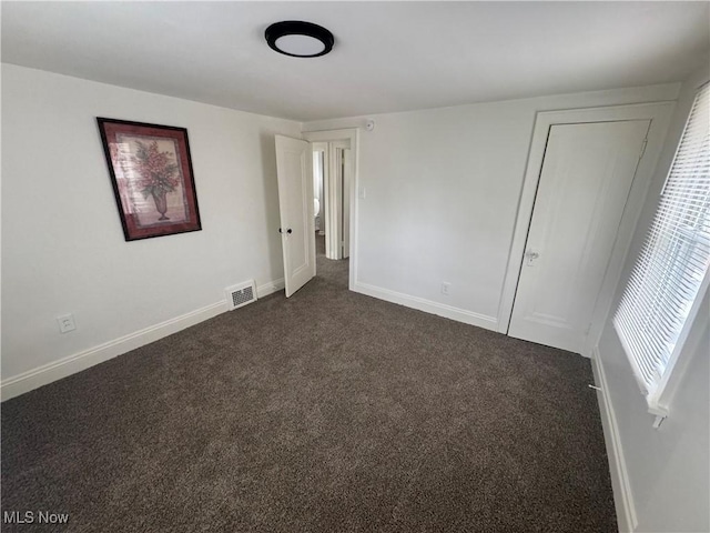 783 Jason Ave, Akron, OH 44314 - unfurnished bedroom featuring dark colored carpet and baseboards