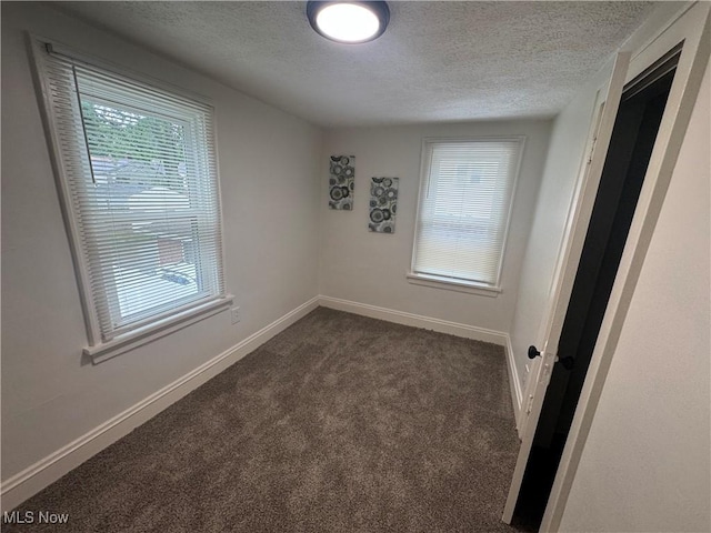 783 Jason Ave, Akron, OH 44314 - unfurnished room with a textured ceiling and dark carpet