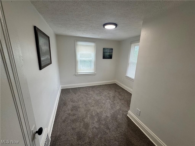 783 Jason Ave, Akron, OH 44314 - spare room featuring dark colored carpet and a textured ceiling