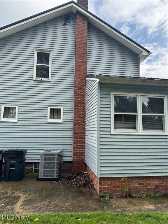 783 Jason Ave, Akron, OH 44314 - view of home's exterior with a central air condition unit and a chimney