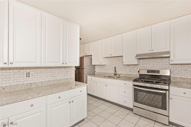 3271 Warrensville Center Rd Unit 4A, Shaker Heights, OH 44122 - kitchen with stainless steel appliances, under cabinet range hood, tasteful backsplash, light tile patterned floors, and white cabinetry