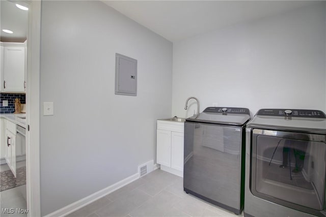 2764 Walter Rd, Westlake, OH 44145 - laundry area featuring electric panel, separate washer and dryer, cabinet space, and light tile patterned floors
