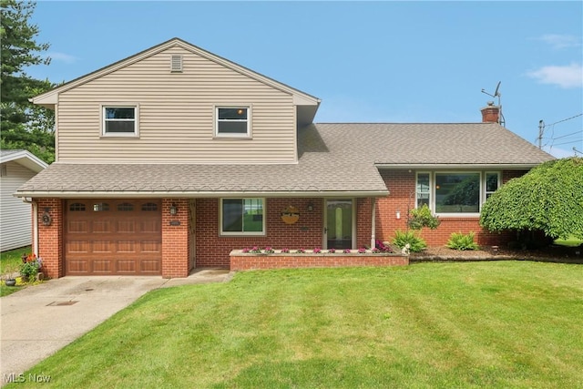 1455 Buckeye Cir, Salem, OH 44460 - view of front of house with brick siding, a garage, a front yard, and driveway