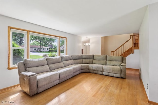 1455 Buckeye Cir, Salem, OH 44460 - living room featuring a chandelier, light wood-type flooring, and stairs
