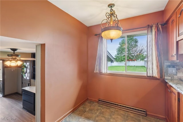 1455 Buckeye Cir, Salem, OH 44460 - unfurnished dining area featuring a baseboard heating unit and ceiling fan