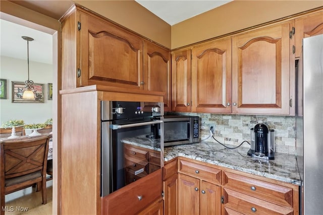 1455 Buckeye Cir, Salem, OH 44460 - kitchen featuring appliances with stainless steel finishes, backsplash, light stone counters, and brown cabinets